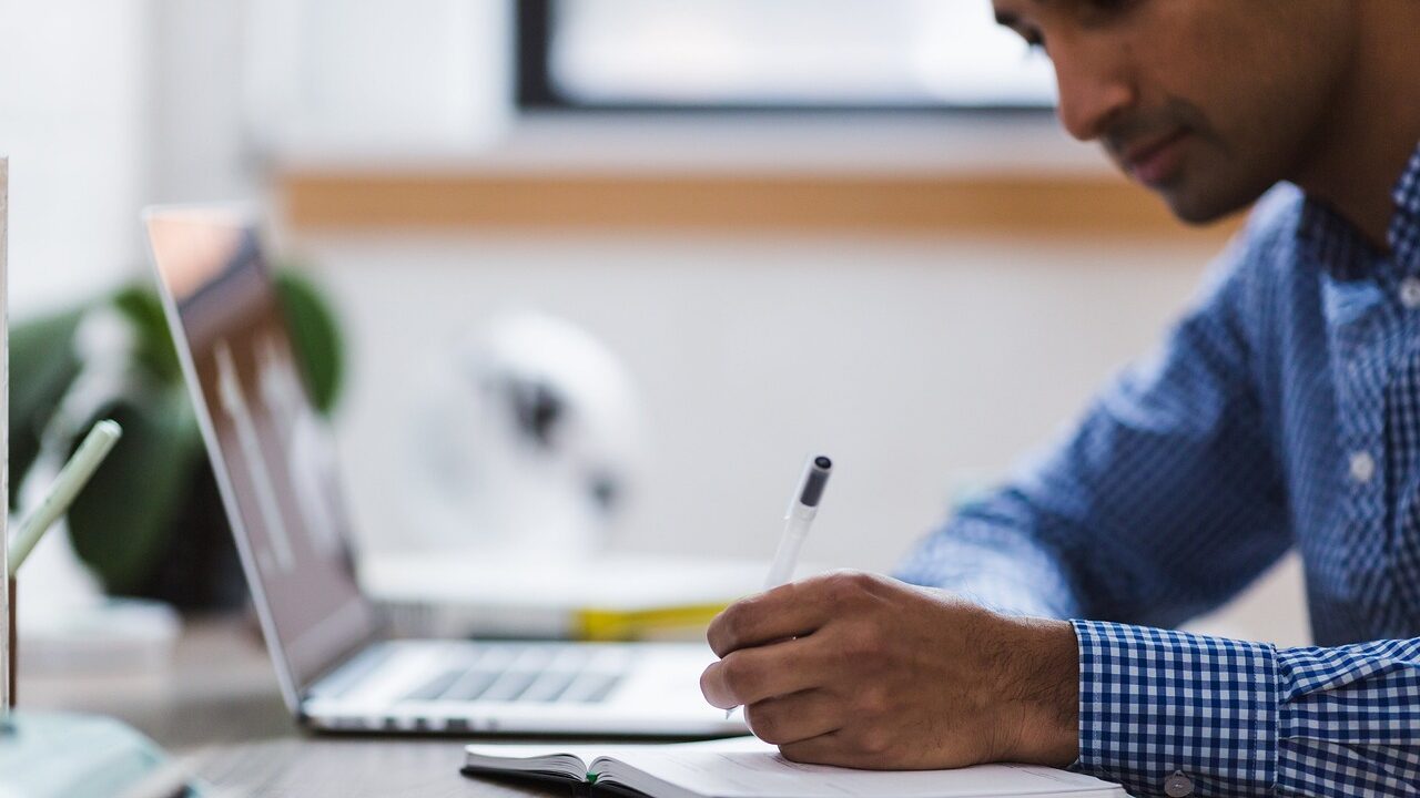 man, writing, laptop